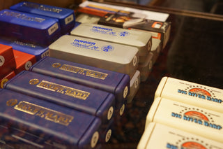 Collection of harmonicas in a display case