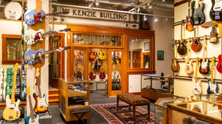 Cozy room with wood trim and electric guitars on the walls