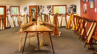 Room full of Dusty Strings lever harps with three hammered dulcimers in the center