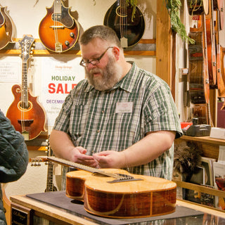 Person restringing a guitar