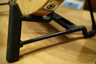 Close-up of a black guitar stand